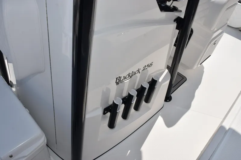 Slide: The Image of 2026 BlackJack 256 Coastal boat interior with rod holders and sleek design. - 22