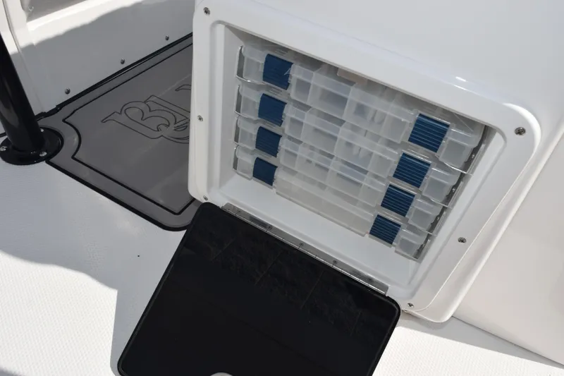 Slide: The Image of Storage compartment with tackle boxes on a 2026 BlackJack 256 Coastal boat. - 23