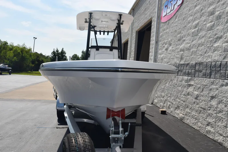 Slide: The Image of 2026 BlackJack 256 Coastal boat on trailer, parked beside a building. - 3