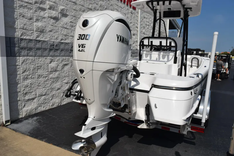 Slide: The Image of 2026 BlackJack 256 Coastal boat with Yamaha 300 V6 engine, parked outdoors. - 5