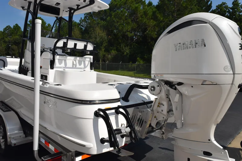 Slide: The Image of 2026 BlackJack 256 Coastal boat with Yamaha outboard motor, parked on a trailer. - 6