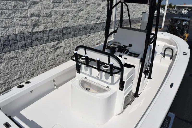 Slide: The Image of 2026 BlackJack 256 Coastal boat interior with steering console and rod holders. - 7