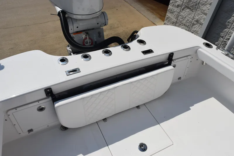 Slide: The Image of 2026 BlackJack 256 Coastal boat interior with foldable seat and rod holders. - 8