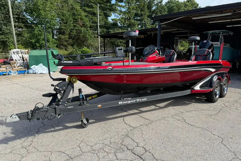 Slide: The Image of 2023 Ranger Z520R boat on trailer, red and black design, parked outdoors. - 0