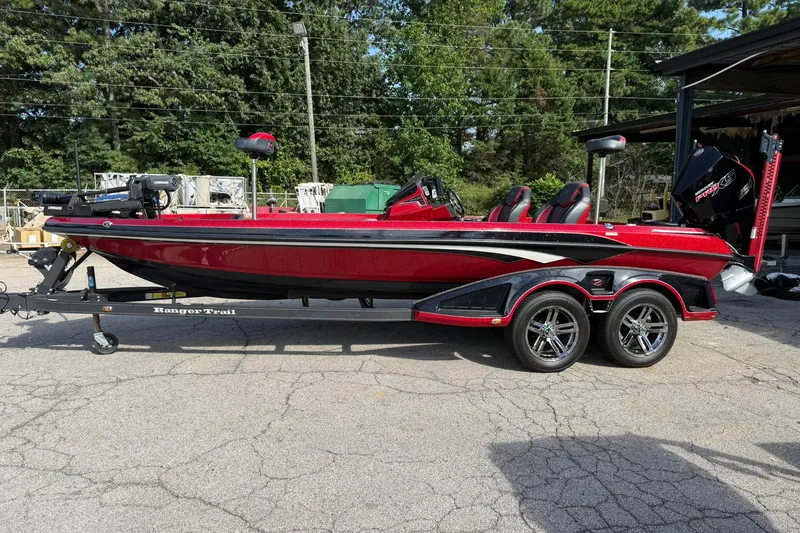 Slide: The Image of 2023 Ranger Z520R boat in vibrant red on a trailer, parked outdoors. - 1