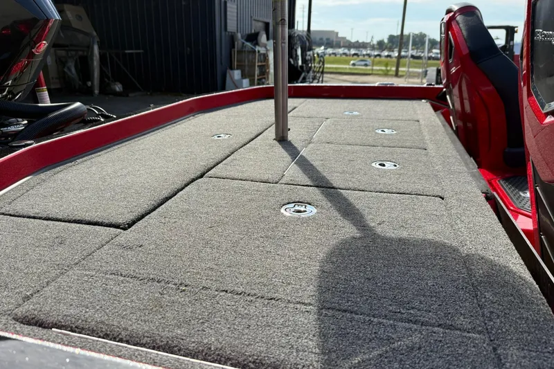 Slide: The Image of 2023 Ranger Z520R boat deck with carpeted surface and storage compartments. - 15