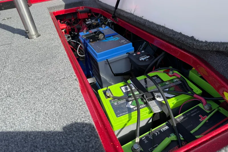 Slide: The Image of 2023 Ranger Z520R boat battery compartment with multiple batteries and wiring. - 16