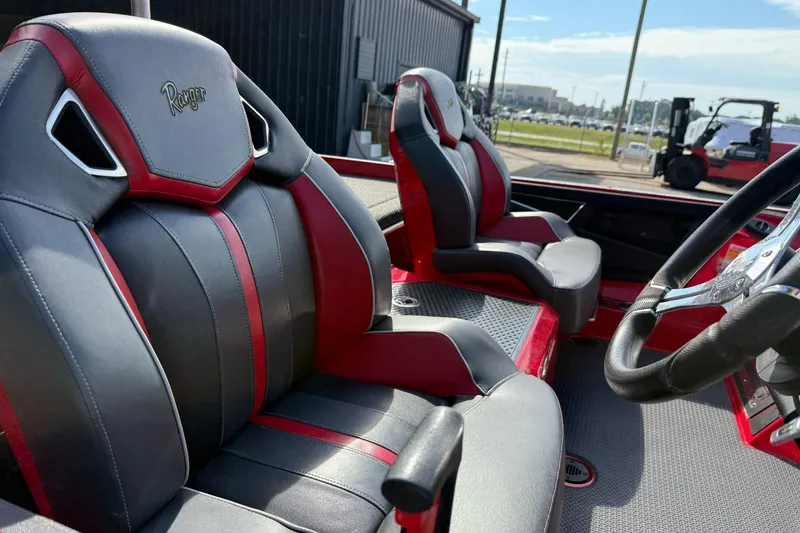 Slide: The Image of 2023 Ranger Z520R boat interior with red and gray seats, steering wheel visible. - 8