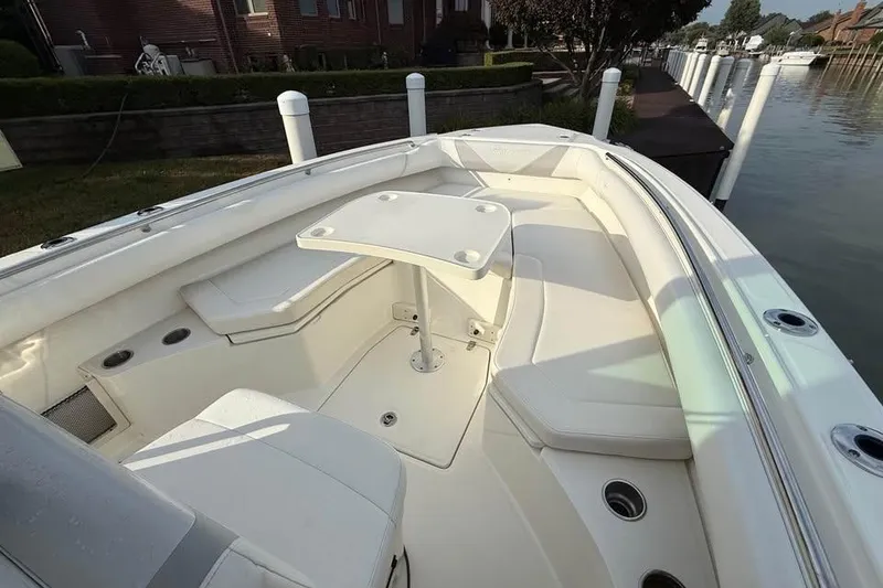 Slide: The Image of 2015 Boston Whaler 280 Outrage boat interior with seating and table. - 13