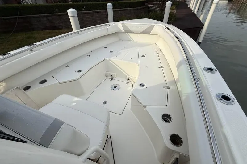 Slide: The Image of 2015 Boston Whaler 280 Outrage boat interior with spacious seating and storage compartments. - 15
