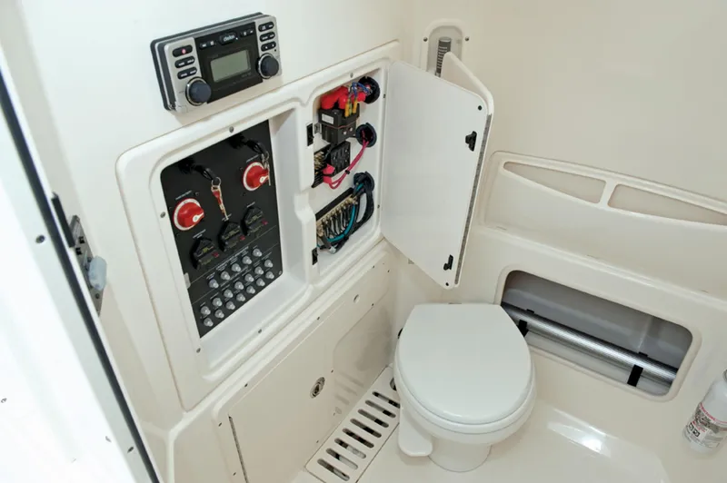 Slide: The Image of Manufacturer Provided Image: 2015 Boston Whaler 280 Outrage boat interior with control panel and toilet. - 17