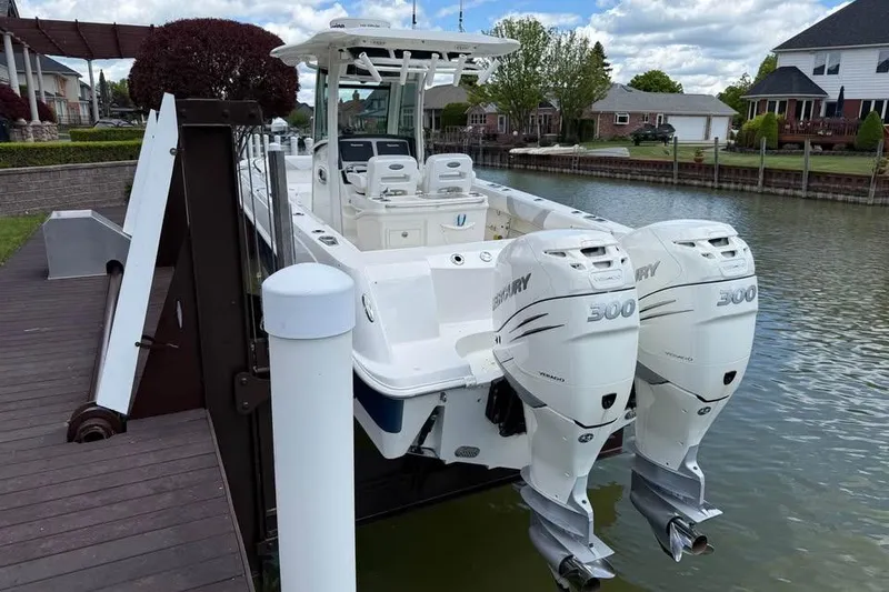 Slide: The Image of 2015 Boston Whaler 280 Outrage with dual Mercury 300 engines docked by waterfront homes. - 6
