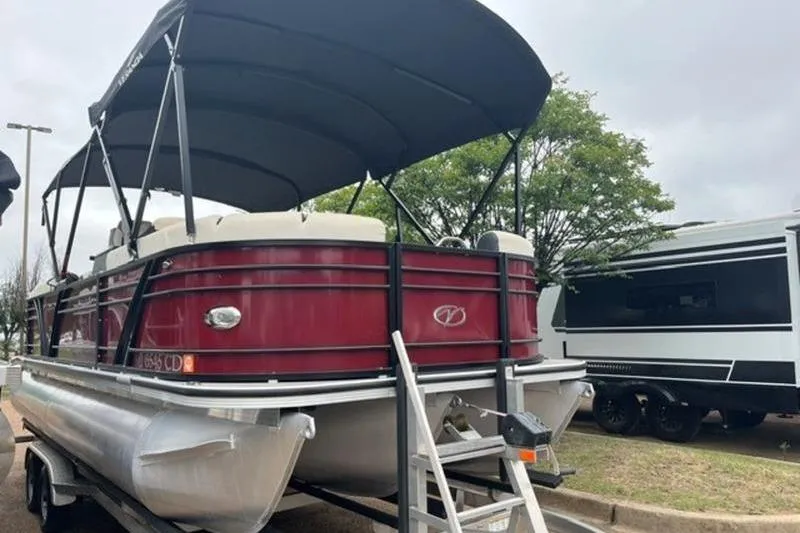 Slide: The Image of 2023 Veranda VP 22RC pontoon boat with canopy, parked on a trailer. - 1