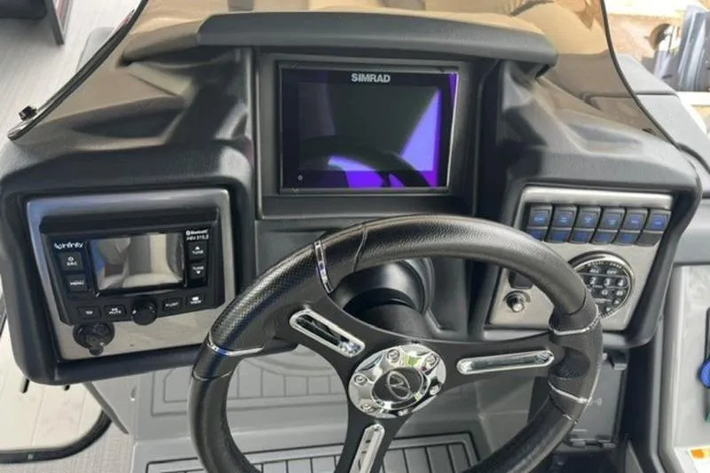 Slide: The Image of 2023 Veranda VP 22RC boat dashboard with steering wheel and Simrad display. - 10