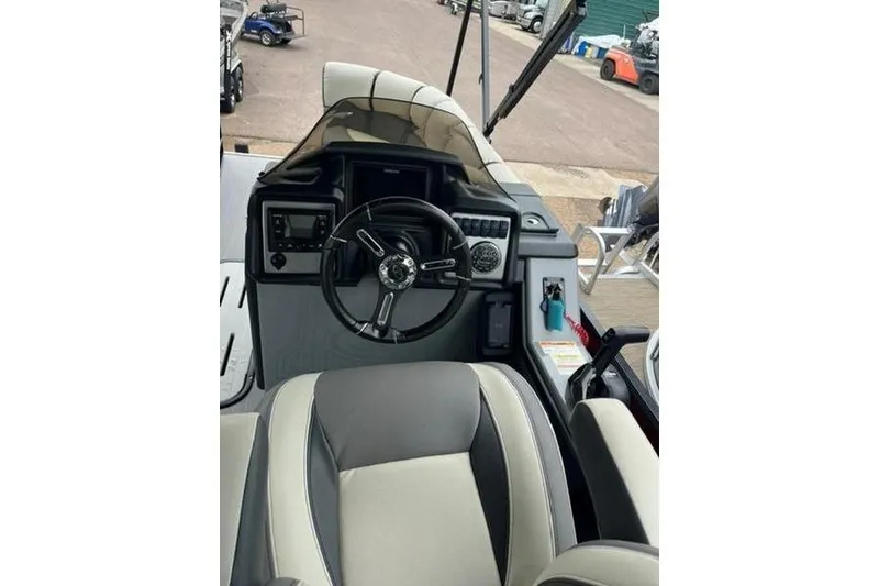 Slide: The Image of 2023 Veranda VP 22RC boat interior with steering wheel and dashboard controls. - 9