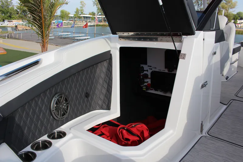 Slide: The Image of 2026 Cobalt R6 boat interior with open storage compartment and speaker. - 12