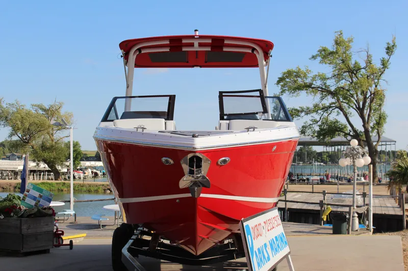 Slide: The Image of 2026 Cobalt R6 boat in vibrant red, docked at a marina under clear blue skies. - 2