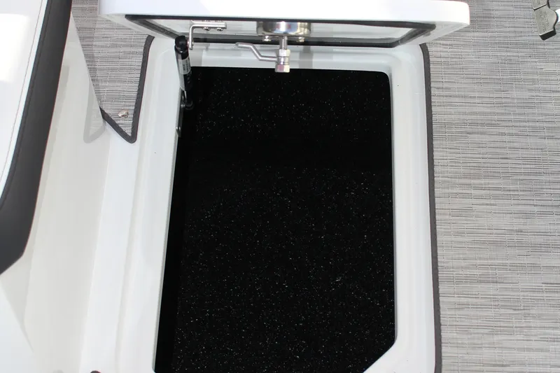 Slide: The Image of Open storage compartment on 2026 Cobalt R6 boat with textured flooring. - 22
