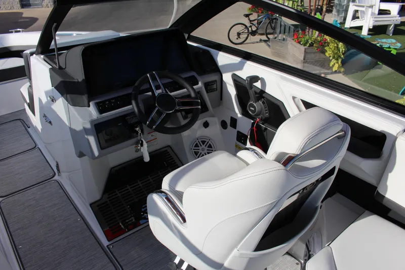 Slide: The Image of 2026 Cobalt R6 boat interior with modern steering wheel and white seating. - 23
