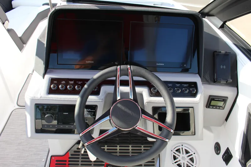 Slide: The Image of 2026 Cobalt R6 boat dashboard with dual Garmin screens and modern controls. - 24