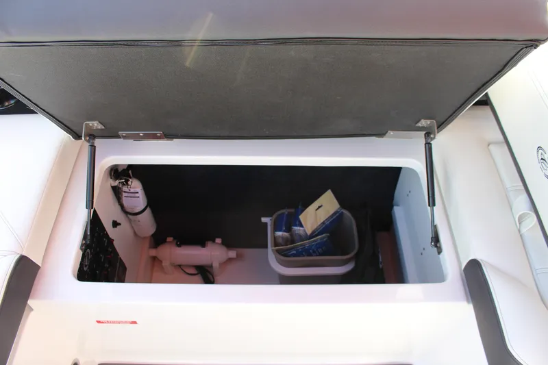 Slide: The Image of Open storage compartment in 2026 Cobalt R6 boat, showing organized interior space. - 25