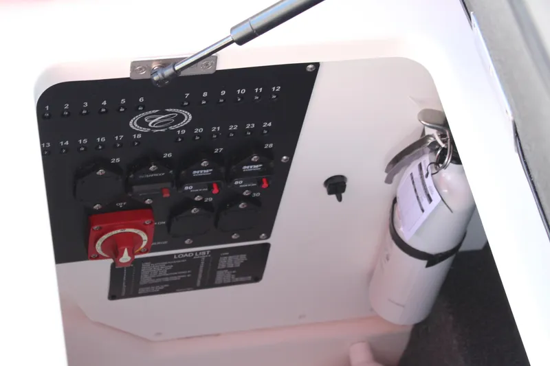 Slide: The Image of Control panel and fire extinguisher in 2026 Cobalt R6 boat compartment. - 26