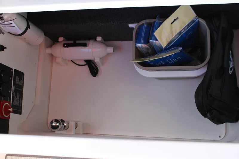 Slide: The Image of Storage compartment in 2026 Cobalt R6 boat with safety equipment and accessories. - 27
