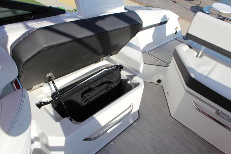 Slide: The Image of 2026 Cobalt R6 boat interior with open storage compartment and seating. - 29