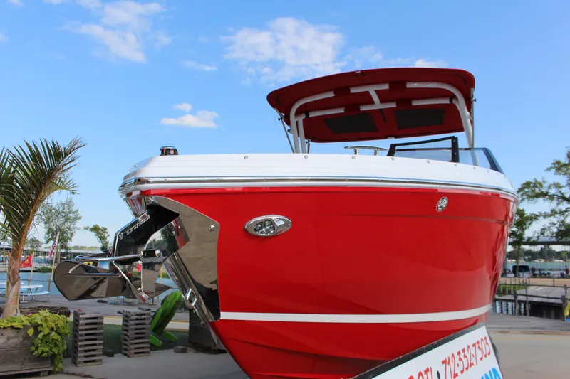 Slide: The Image of 2026 Cobalt R6 boat in vibrant red, docked under a clear blue sky. - 3