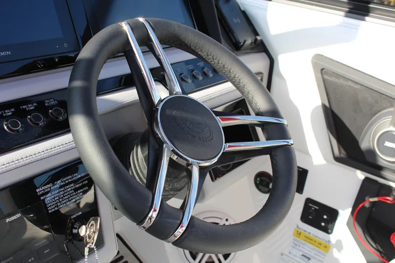 Slide: The Image of Steering wheel of 2026 Cobalt R6 boat with control panel and speaker. - 31