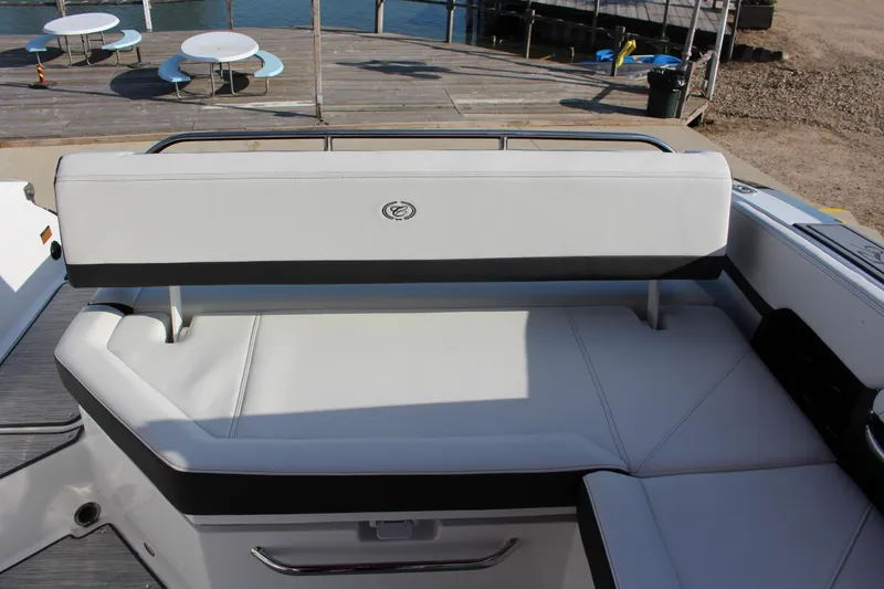 Slide: The Image of 2026 Cobalt R6 boat interior with white seating, dockside view. - 34