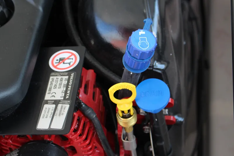 Slide: The Image of Engine components of a 2026 Cobalt R6, featuring labeled caps and warning sticker. - 38