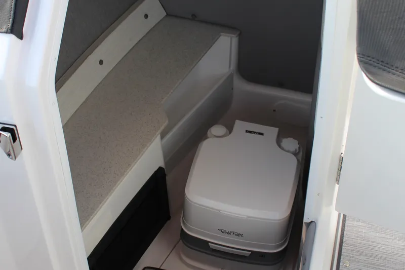 Slide: The Image of 2026 Cobalt R6 boat interior with portable toilet and seating area. - 4