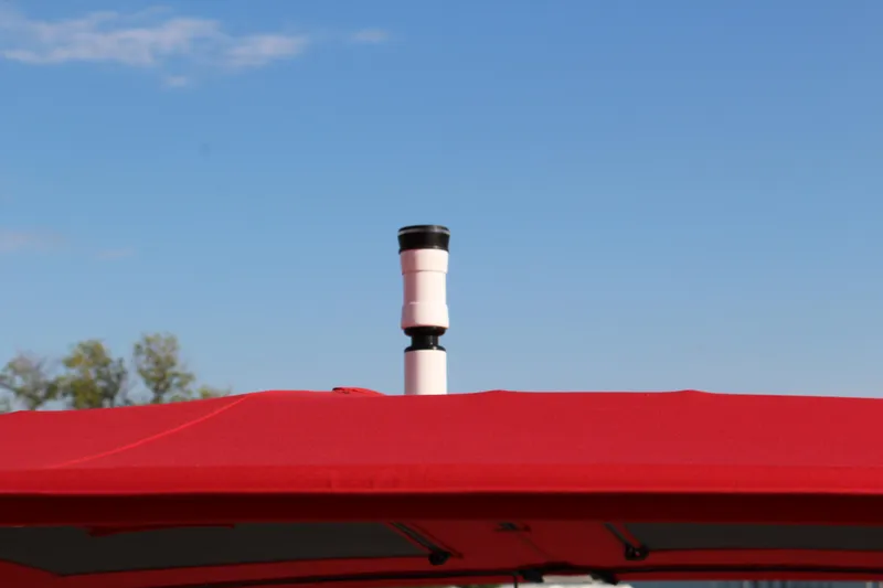 Slide: The Image of Red canopy on 2026 Cobalt R6 boat under clear blue sky. - 53