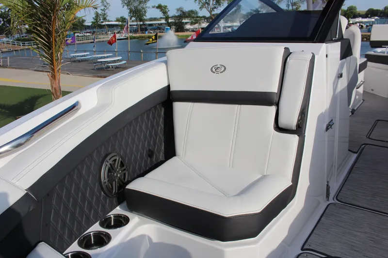 Slide: The Image of 2026 Cobalt R6 boat interior with luxurious seating and cup holders by a scenic waterfront. - 6