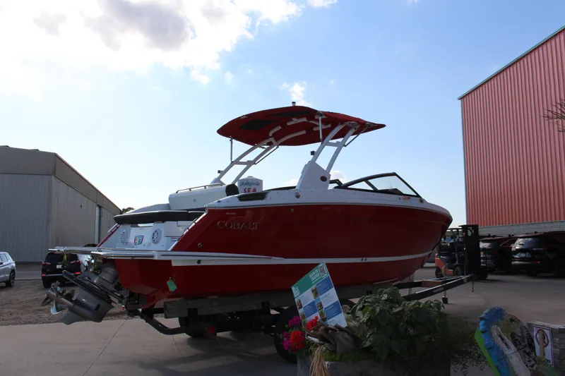 Slide: The Image of 2026 Cobalt R6 boat in vibrant red on a trailer, outdoor display. - 69