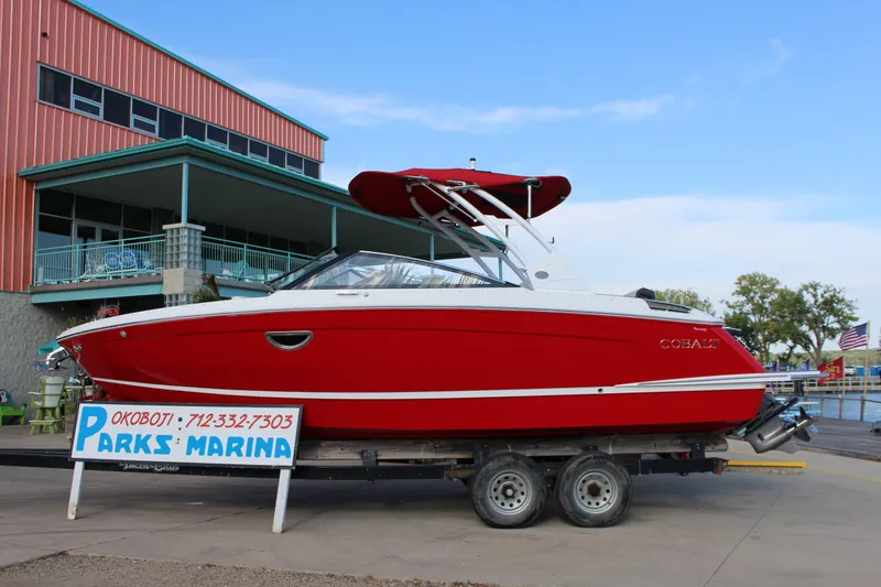 Slide: The Image of 2026 Cobalt R6 boat in red at Parks Marina, displayed on a trailer. - 71