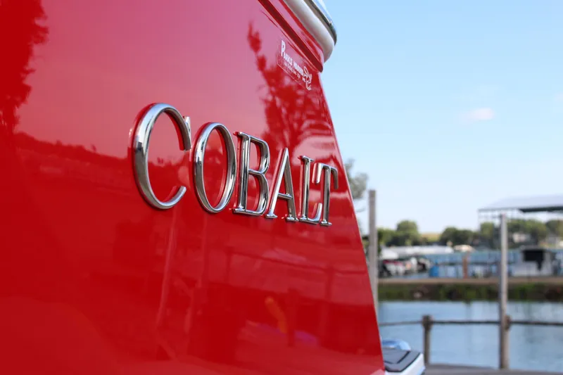 Slide: The Image of Red 2026 Cobalt R6 boat with chrome logo, dockside view. - 72