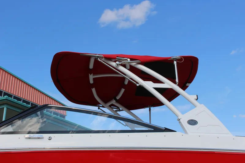 Slide: The Image of 2026 Cobalt R6 boat with red canopy against blue sky. - 75