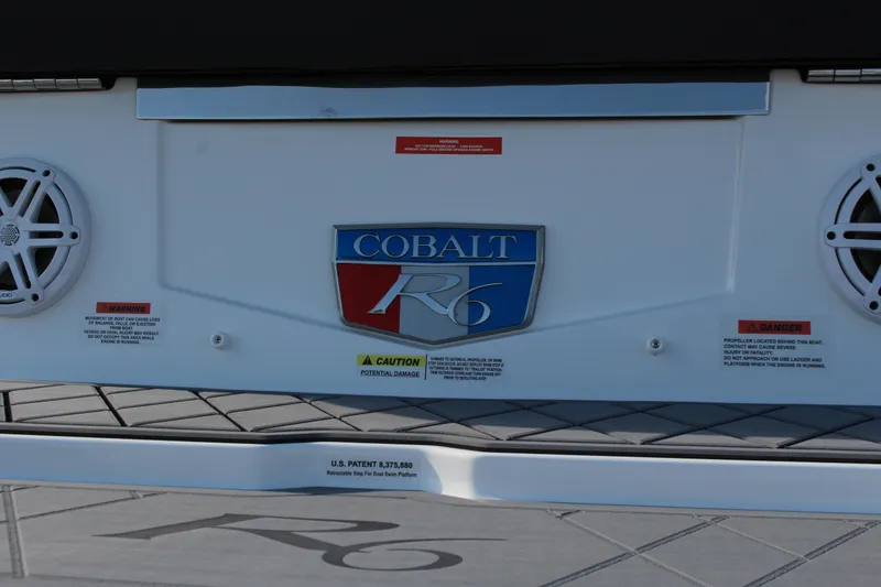 Slide: The Image of 2026 Cobalt R6 boat rear view with logo and safety warnings. - 79