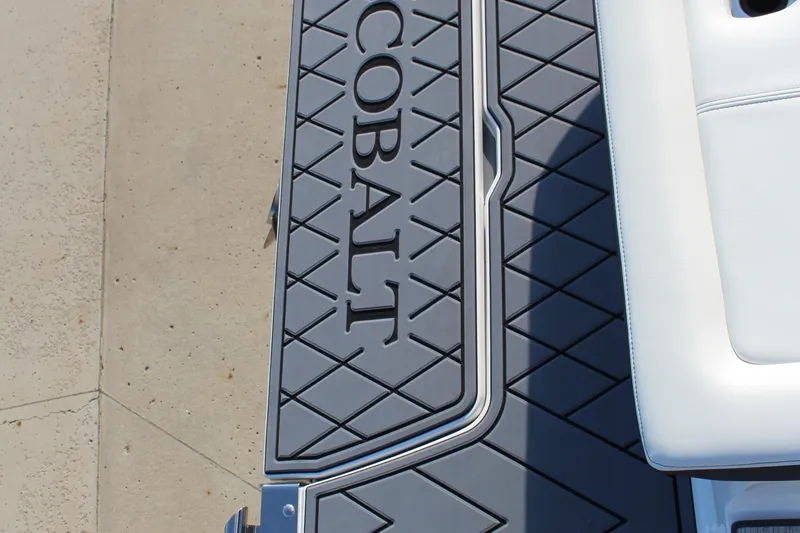 Slide: The Image of 2026 Cobalt R6 boat deck with logo and white seating. - 82