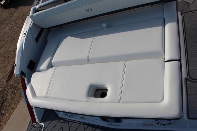 Slide: The Image of 2026 Cobalt R6 boat with white cushioned seating area, viewed from above. - 83