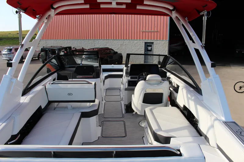 Slide: The Image of 2026 Cobalt R6 boat interior with white seating and red canopy. - 84