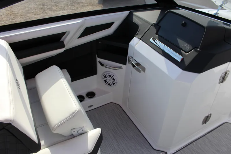Slide: The Image of Interior of 2026 Cobalt R6 boat featuring sleek white seating and modern dashboard design. - 92