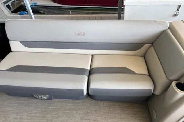 Slide: The Image of 2022 Princecraft Sportfisher 23-2S RL boat seating, gray and white upholstery, docked. - 10