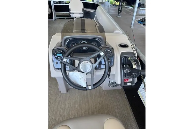 Slide: The Image of 2022 Princecraft Sportfisher 23-2S RL boat dashboard with steering wheel and controls. - 13