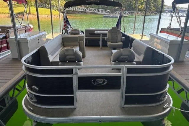 Slide: The Image of 2022 Princecraft Sportfisher 23-2S RL pontoon boat docked on a serene lake. - 17
