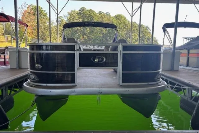 Slide: The Image of 2022 Princecraft Sportfisher 23-2S RL pontoon boat docked on vibrant green water. - 18