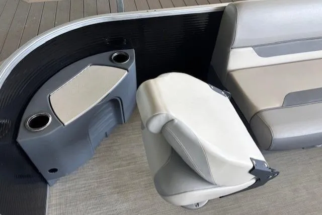 Slide: The Image of 2022 Princecraft Sportfisher 23-2S RL boat interior with seating and cup holders. - 6