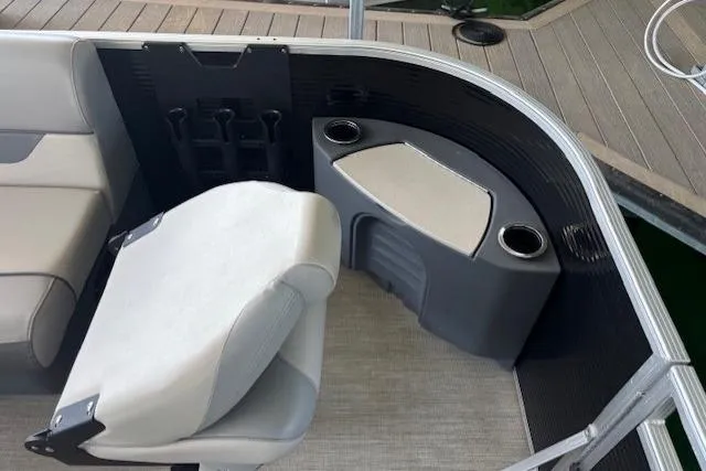 Slide: The Image of 2022 Princecraft Sportfisher 23-2S RL boat interior with seating and cup holders. - 7
